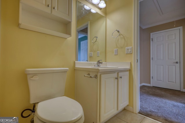 half bathroom with toilet, vanity, tile patterned flooring, and baseboards