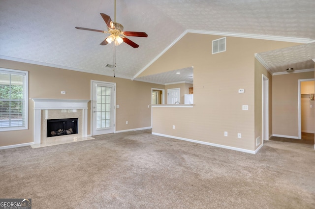 unfurnished living room with ceiling fan, baseboards, carpet, a premium fireplace, and ornamental molding