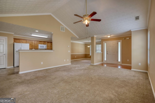 unfurnished living room with light colored carpet, ceiling fan, baseboards, crown molding, and high vaulted ceiling