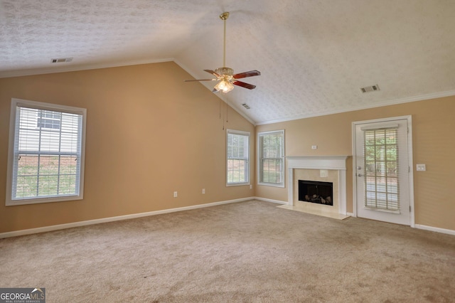 unfurnished living room with plenty of natural light, ceiling fan, baseboards, carpet flooring, and lofted ceiling