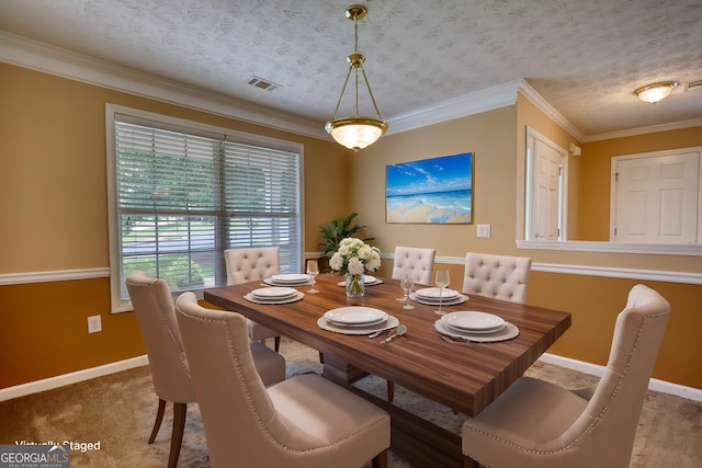 dining room featuring baseboards, crown molding, and carpet floors