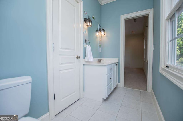 bathroom featuring tile patterned flooring, baseboards, vanity, and toilet