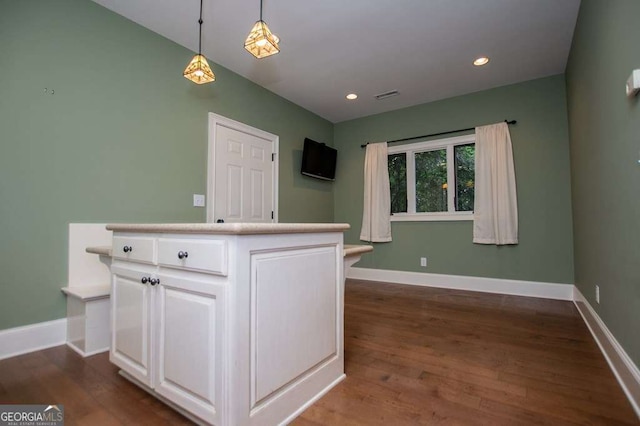kitchen featuring baseboards, white cabinets, dark wood finished floors, and recessed lighting