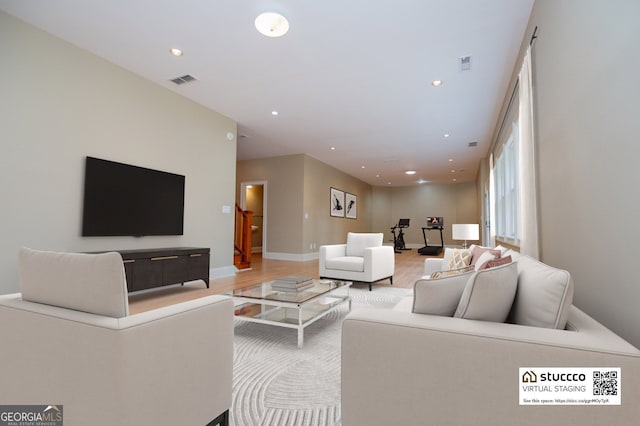 living area with wood finished floors, recessed lighting, and baseboards