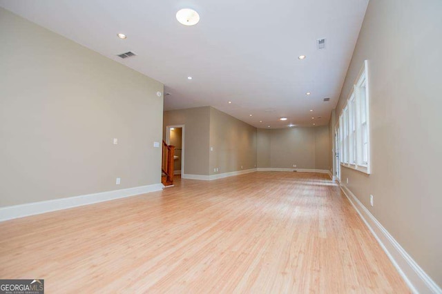 spare room with light wood-style flooring, recessed lighting, and baseboards