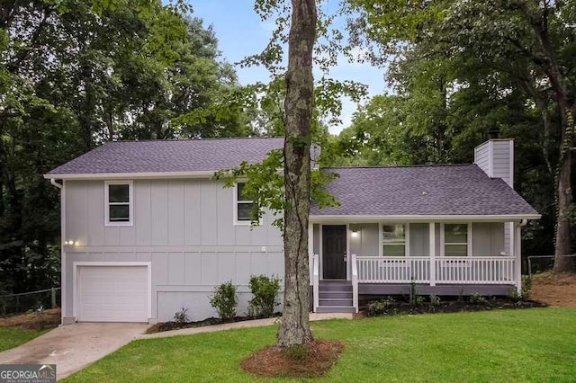 434 Mona Pl, Dallas, GA 30132 - view of front of home featuring a front lawn, a chimney, covered porch, a garage, and a shingled roof