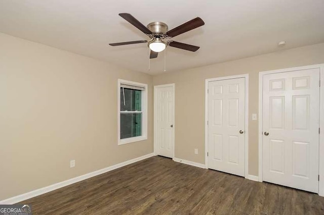 434 Mona Pl, Dallas, GA 30132 - unfurnished bedroom featuring dark wood-type flooring, baseboards, and a ceiling fan