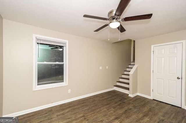 434 Mona Pl, Dallas, GA 30132 - empty room featuring dark wood finished floors, ceiling fan, baseboards, and stairway