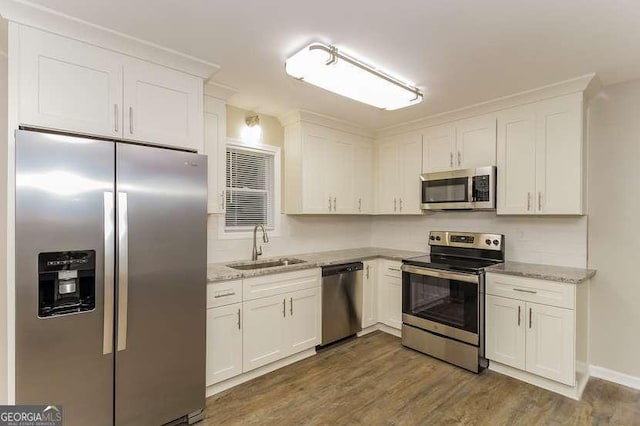 434 Mona Pl, Dallas, GA 30132 - kitchen with stainless steel appliances, a sink, white cabinets, dark wood-type flooring, and light stone countertops