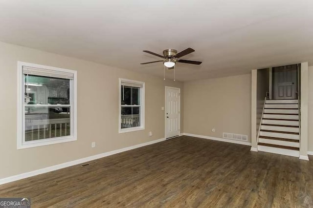 434 Mona Pl, Dallas, GA 30132 - empty room with ceiling fan, dark wood-type flooring, stairs, and baseboards