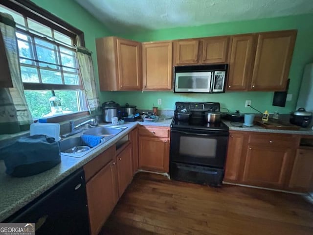 1711 Mckenzie Dr, Decatur, GA 30032 - kitchen featuring black appliances, dark wood-type flooring, a sink, light countertops, and a textured ceiling