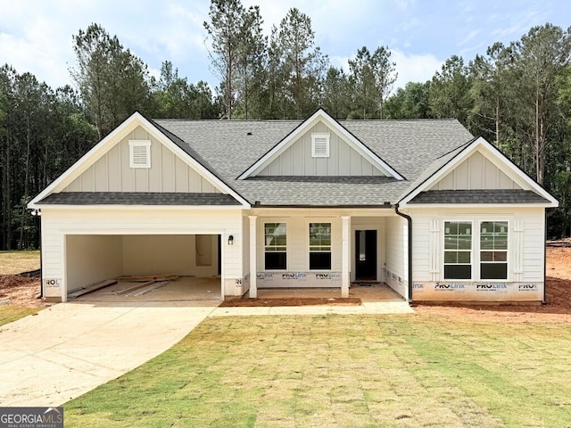 113 Donnie Way, Statham, GA 30666 - view of front of property featuring roof with shingles, an attached garage, concrete driveway, a front yard, and board and batten siding