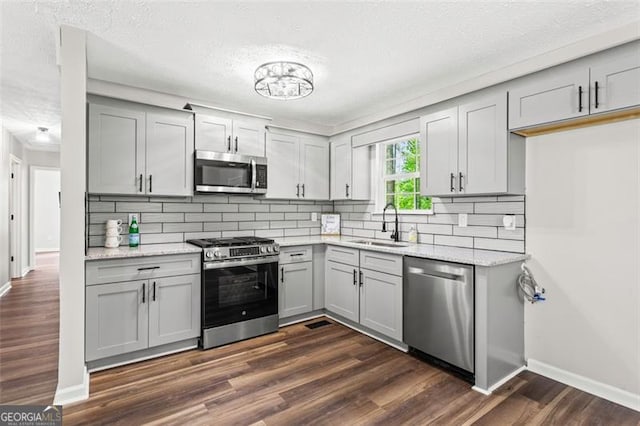 86 Williams Rd, Dallas, GA 30132 - kitchen featuring appliances with stainless steel finishes, a sink, gray cabinetry, baseboards, and a textured ceiling