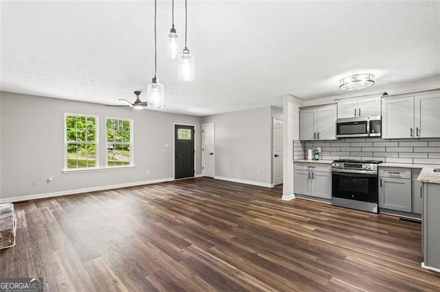 86 Williams Rd, Dallas, GA 30132 - kitchen with stainless steel appliances, gray cabinets, open floor plan, baseboards, and a textured ceiling