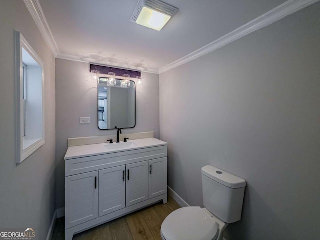 136 Oak St Unit 0, Omega, GA 31775 - half bathroom featuring wood finished floors, ornamental molding, toilet, vanity, and baseboards