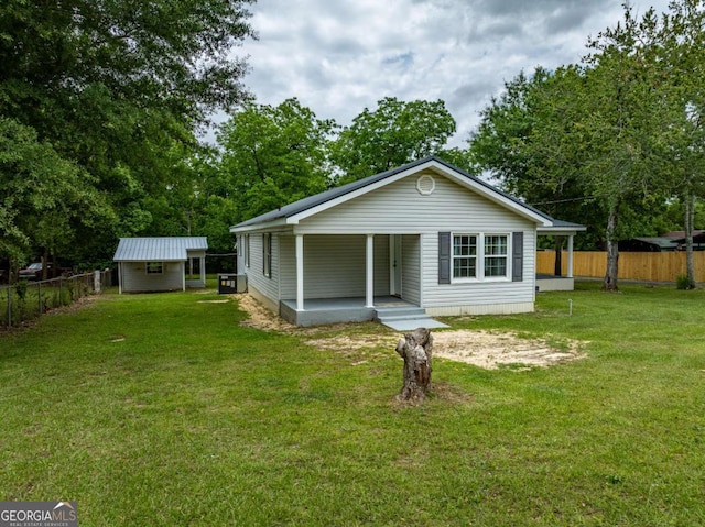 136 Oak St Unit 0, Omega, GA 31775 - rear view of property featuring a porch and an outbuilding