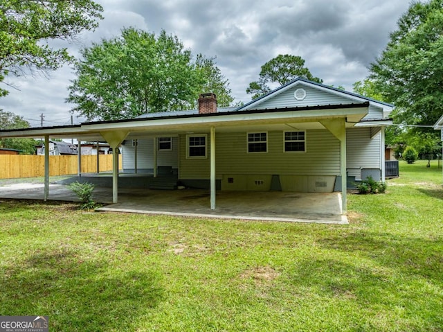 136 Oak St Unit 0, Omega, GA 31775 - rear view of house featuring a carport, a chimney, crawl space, metal roof, and central AC