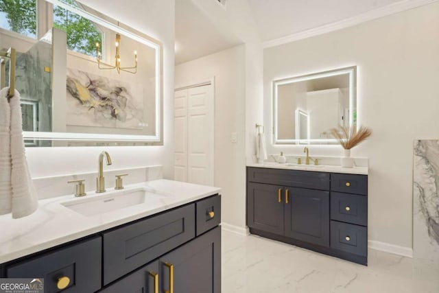 full bath with marble finish flooring, baseboards, two vanities, and ornamental molding