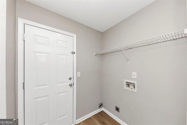 1023 Saint Augustine Pkwy, Locust Grove, GA 30248 - laundry room with hookup for an electric dryer, washer hookup, wood finished floors, and baseboards