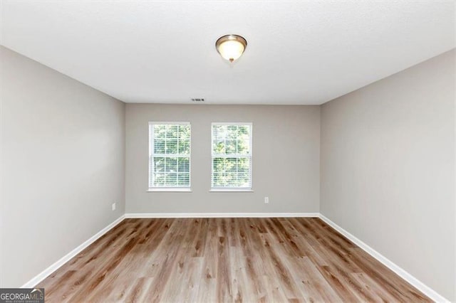 1023 Saint Augustine Pkwy, Locust Grove, GA 30248 - spare room with baseboards and light wood-style floors