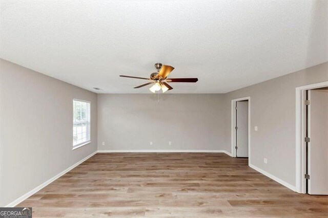 1023 Saint Augustine Pkwy, Locust Grove, GA 30248 - spare room with ceiling fan, light wood-style floors, baseboards, and a textured ceiling