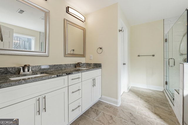 7902 W Shore Cir, Riverdale, GA 30296 - bathroom featuring baseboards, a shower stall, stone finish flooring, and double vanity