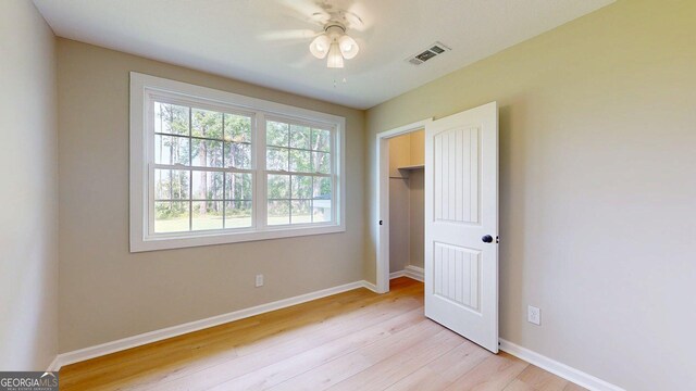 4656 Old River Rd N, Statesboro, GA 30461 - unfurnished bedroom featuring light wood-style floors, a ceiling fan, and a closet