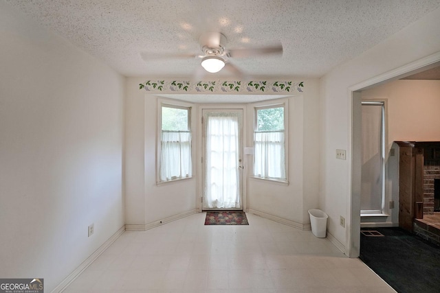 251 Lambeth Dr, Hiram, GA 30141 - entryway with a ceiling fan, tile patterned floors, a textured ceiling, and baseboards