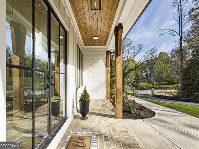 2000 Birmingham Rd, Milton, GA 30004 - living area featuring beamed ceiling, a chandelier, a glass covered fireplace, and recessed lighting