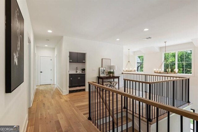 2000 Birmingham Rd, Milton, GA 30004 - hallway with a chandelier, an upstairs landing, light wood-type flooring, and recessed lighting