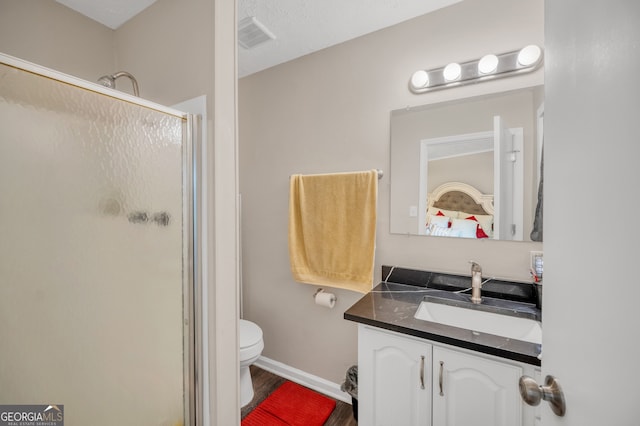 83 Summit Ridge Cir SE, Cartersville, GA 30120 - bathroom with a shower stall, vanity, toilet, wood finished floors, and baseboards