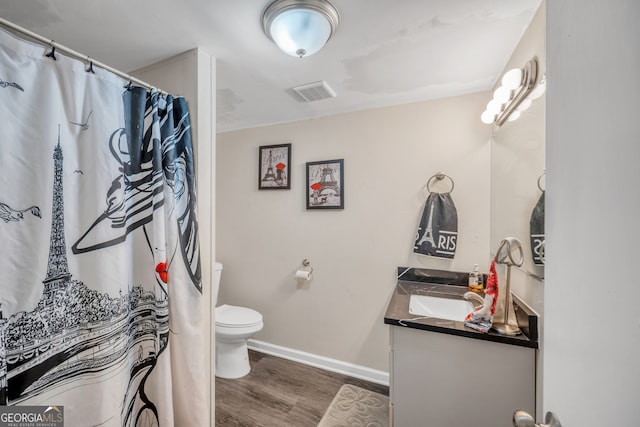 83 Summit Ridge Cir SE, Cartersville, GA 30120 - bathroom with wood finished floors, vanity, baseboards, toilet, and a shower with shower curtain