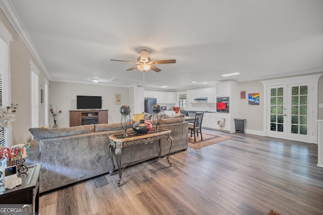 83 Summit Ridge Cir SE, Cartersville, GA 30120 - living area with light wood-type flooring, a ceiling fan, plenty of natural light, ornamental molding, and french doors