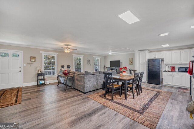 83 Summit Ridge Cir SE, Cartersville, GA 30120 - dining space with ornamental molding, wood finished floors, ceiling fan, and baseboards