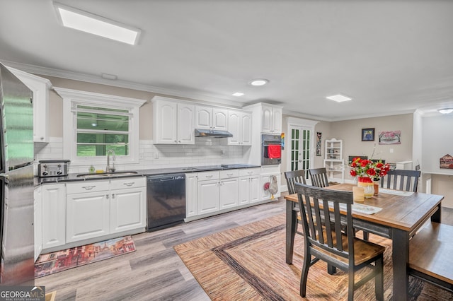 83 Summit Ridge Cir SE, Cartersville, GA 30120 - kitchen with a sink, black appliances, dark countertops, white cabinets, and light wood-style floors