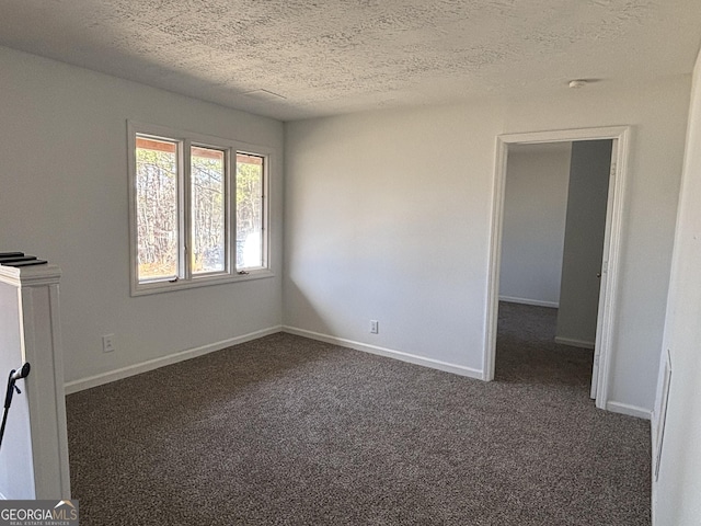 175 Thigpen Rd, Newnan, GA 30263 - empty room featuring dark carpet, a textured ceiling, and baseboards