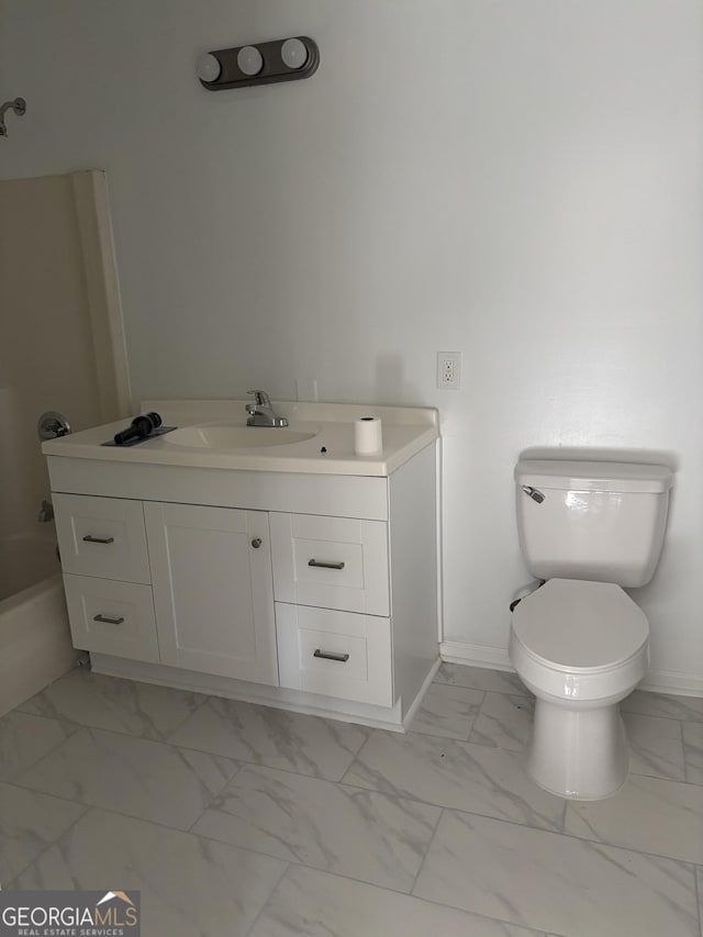 175 Thigpen Rd, Newnan, GA 30263 - bathroom with marble look tile flooring, baseboards, vanity, and toilet