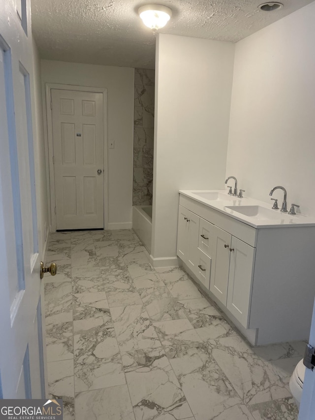 175 Thigpen Rd, Newnan, GA 30263 - full bath with marble finish floors, a textured ceiling, vanity, baseboards, and toilet