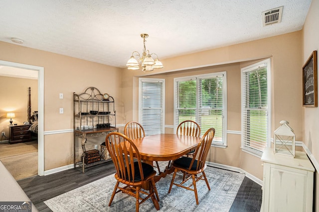 325 N Oakland Cir, Mcdonough, GA 30253 - dining room with wood finished floors, a chandelier, baseboards, and a textured ceiling