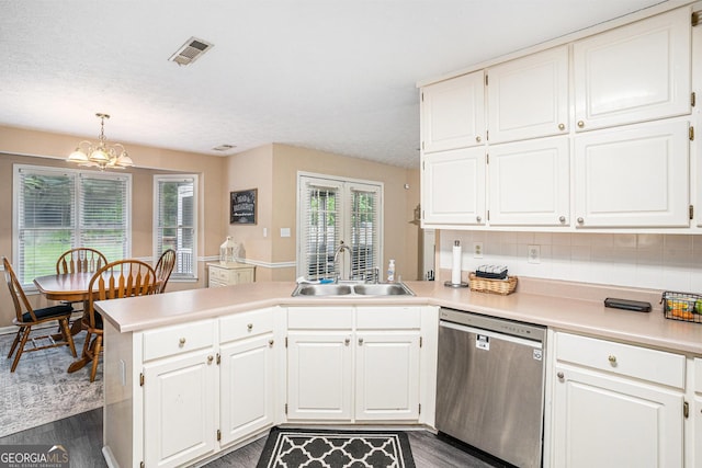 325 N Oakland Cir, Mcdonough, GA 30253 - kitchen featuring stainless steel dishwasher, a peninsula, a sink, a chandelier, and light countertops