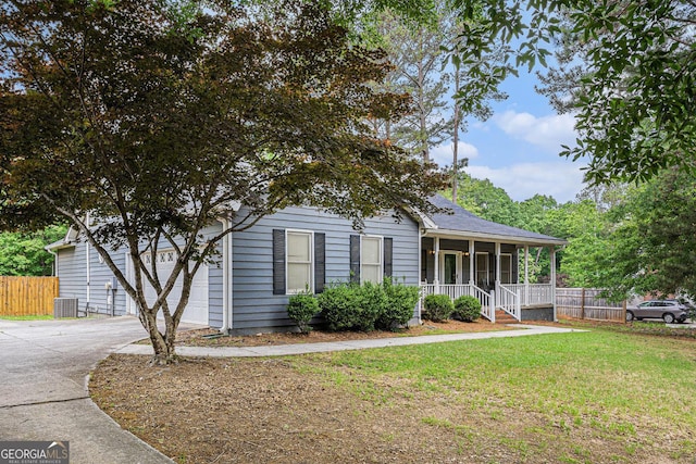 325 N Oakland Cir, Mcdonough, GA 30253 - view of front of home with a porch, driveway, an attached garage, central AC unit, and roof with shingles