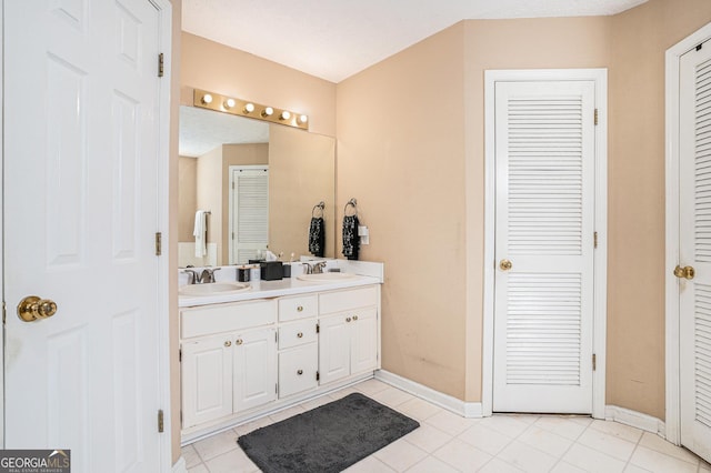 325 N Oakland Cir, Mcdonough, GA 30253 - bathroom with tile patterned floors, double vanity, baseboards, and a closet