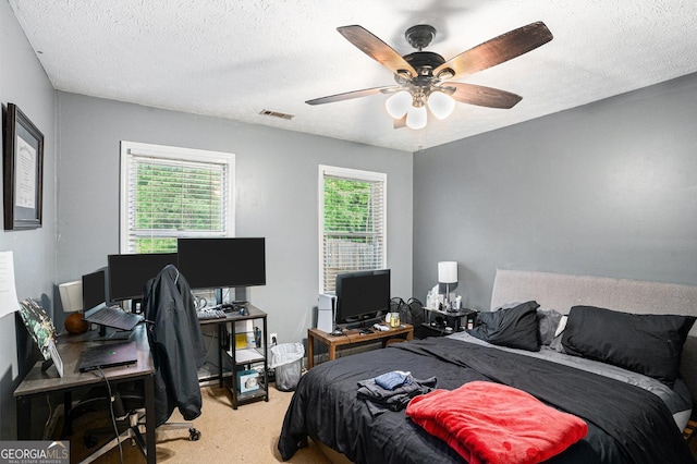 325 N Oakland Cir, Mcdonough, GA 30253 - carpeted bedroom featuring an office area, a textured ceiling, and a ceiling fan