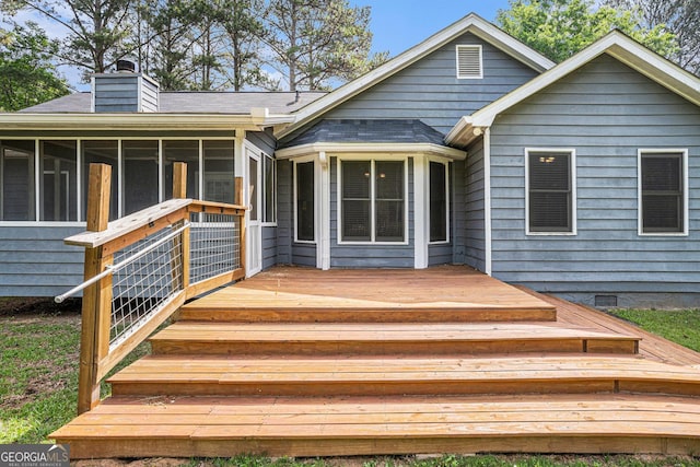 325 N Oakland Cir, Mcdonough, GA 30253 - rear view of house with a sunroom, a chimney, a deck, and roof with shingles
