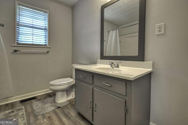 full bath featuring wood finished floors, baseboards, vanity, toilet, and a shower with shower curtain