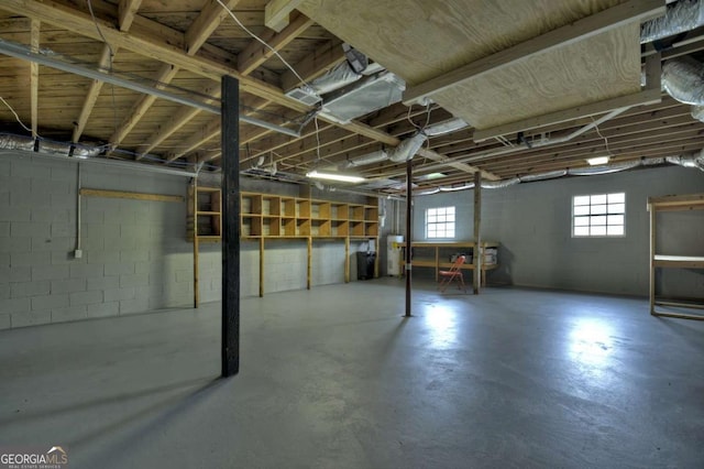 basement with water heater and concrete block wall