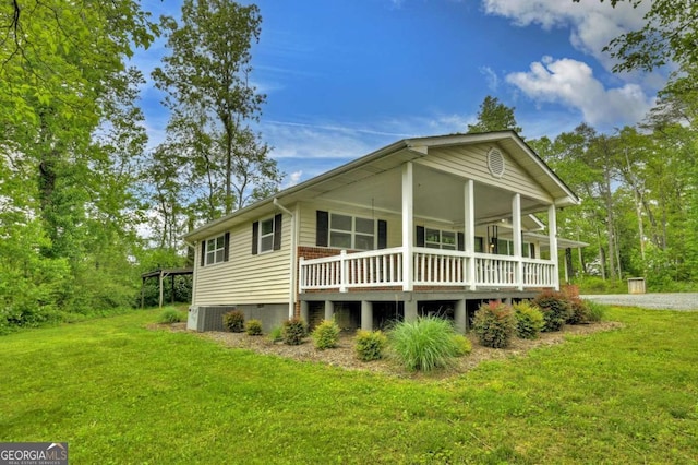 back of house with a lawn and central AC unit