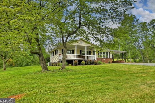 view of front facade with a porch, a front lawn, driveway, and an attached carport