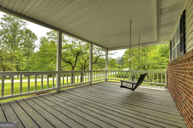 wooden terrace with view of wooded area