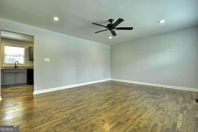 spare room with a sink, dark wood-style floors, ceiling fan, baseboards, and recessed lighting